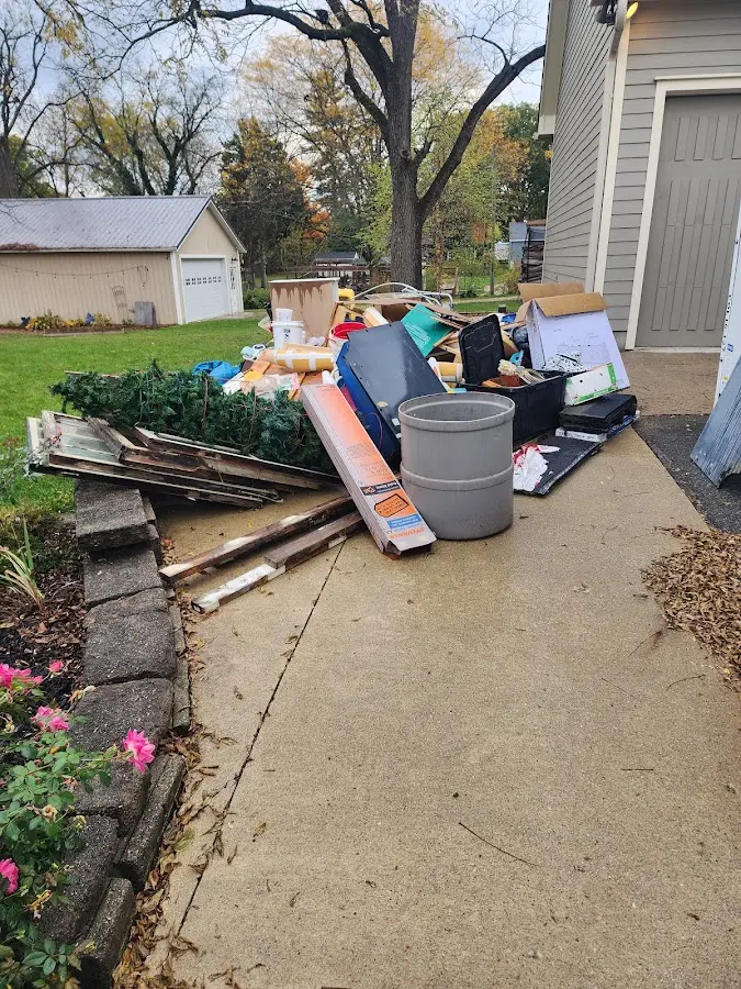 Dumpster being loaded with debris for 12 Yard Dumpster Rental in Pelican Marsh